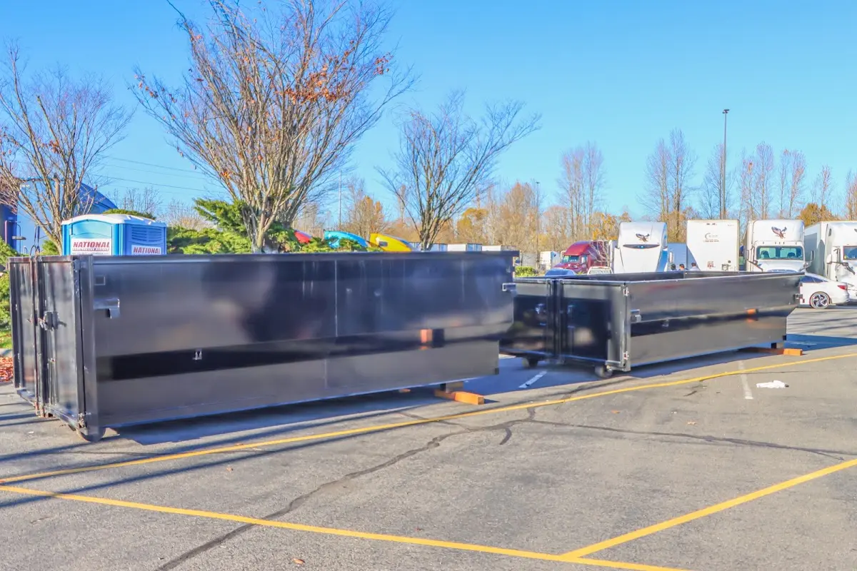 Professional dumpster rental service with roll-off container on residential driveway in Hughson